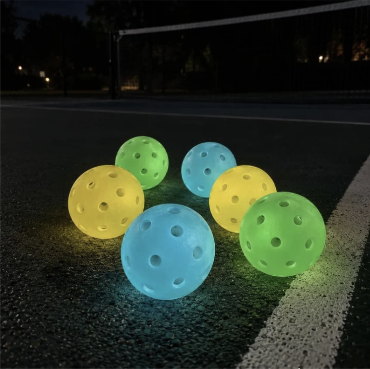 Six Glow Pickleballs on Night Court